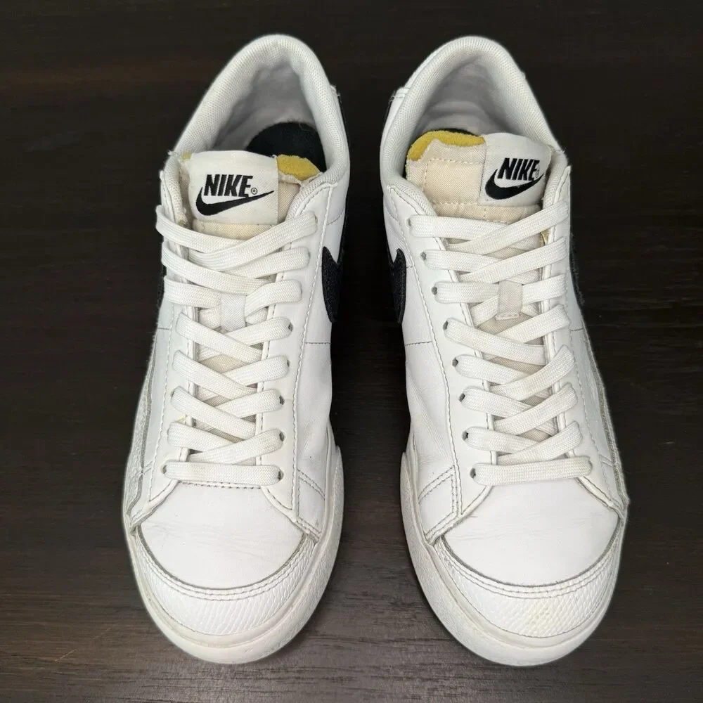 Nike White Leather Low-Top Sneakers with Black Swoosh and Yellow Tongue